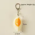 Realistic PVC boiled egg keychain pendant with orange yolk and white egg white - 1/4 Soft-boiled Egg - Lobster Clasp