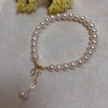 Detailed close-up of Baroque pearl bracelet with 14K gold lobster clasp and heart pendant - Freshwater Pearl Zircon Pendant Style (SL7-5)