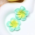 Close-up of resin plumeria flower accessories with blue and yellow gradient petals - Large Light Green