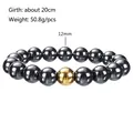 Detail view of 12mm black hematite beads with a gold accent on a 20cm elastic bracelet - 12mm