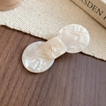 Detail of cream white acetate hair clip with geometric shapes and marble texture on wood - Geometric Bow Style / White / Large