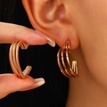Detail shot of oversized gold triple-layered heart hoop earrings worn on ear - Triple Layer Hollow Heart (1266)