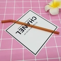 Reusable amber bent borosilicate glass straw placed on a pink checkered background - 8*200mm / Amber Yellow Bent