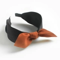 Black wide headband featuring a stylish orange-brown fabric bow tie for women - Black Orange Bow