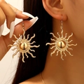 Macro detail of large gold sunburst earrings featuring creative 3D ray pattern - Bright Gold Sunburst Drop Earrings (1147)