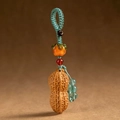 Detail of handcrafted rosewood persimmon and peanut keychain charm with woven cord - Good Things Happen Peanut Keychain