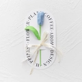 Detail of handcrafted blue crochet tulip with green stem and Love Is Eternal ribbon - Closed Tulip - Light Blue