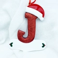 Sparkly red letter J Christmas tree ornament with Santa hat and holly leaves detail - Letter J