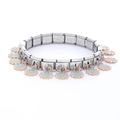 Close-up of stainless steel modular bracelet featuring blue daisy flower charms - 0063-colored Ten-petal Flower Basket (section 1)