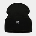 Close-up of black knitted beanie featuring detailed white airplane embroidery on the folded cuff - Black