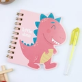 Detail of pink cartoon dinosaur notebook with golden spiral coil and a yellow highlighter - Dinosaur