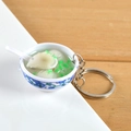 Miniature blue and white porcelain bowl keychain featuring realistic wonton soup - Dumpling