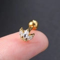 Golden lotus stud earring with marquise cubic zirconia held on a fingertip - Style CC004-14 / Lotus Design Stud / Gold