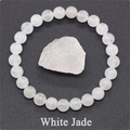 Macro view of white jade beaded elastic bracelet shown with raw natural stone - White Jade