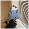 Detalle de bolso concha azul claro en cuero lichi con cadena de cuentas plateadas - Azul