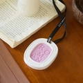 White ceramic aromatherapy sachet with pink Roman wax insert and black ribbon hanger - English Pear & Freesia - Oval