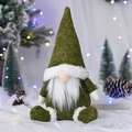 Detail of a green Nordic Christmas gnome featuring a long white beard and a pointed felt hat - Green Sitting Doll