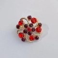 Golden flower brooch featuring elegant openwork design with sparkling red rhinestones - Red Hollow Flower