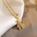 Macro shot of gold-plated bear pendant with white and orange cubic zirconia on satin - Orange and White Zirconia Bear (23656)