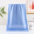 Thick light blue cotton towel with honeycomb textured border hanging in a cozy bathroom - Blue Honeycomb Pattern