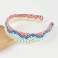 Detail of colorful hand-knitted bohemian headband with wavy crochet pattern and floral design - Blue Pattern