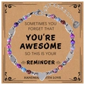 Close-up of a 4mm lapis lazuli heart pendant bracelet on an inspirational card - Purple Sandalwood Stone