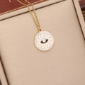 Detail of gold evil eye pendant with white enamel and crystals in a textured box - White