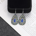 Detail of vintage silver boho teardrop earrings with colorful enamel on a book - Teardrop Multi-color Enamel Style (E2341)