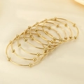 Three-piece set of golden titanium steel bangle bracelets with polished round beads - Inner Diameter 60mm / 7 Rings / Gold