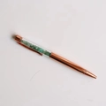 Detailed view of rose gold crystal pen with green aventurine stones in transparent barrel - Aventurine Jade