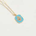 Golden necklace with blue enamel Hamsa hand pendant featuring sparkling crystals - Blue