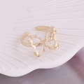 Macro view of gold butterfly ring with hollow wings and sparkling crystal details - One Size / White