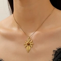 Golden necklace with brown tiger eye sunburst pendant worn by a female model - Gold Military Cross Necklace Style (DZ-936)