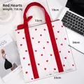 Quilted white tote bag with red heart pattern and ribbon handles for daily use - Red Heart