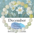 Macro detail of 8mm green natural stone birthstone bracelet for December on gift card - December