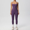 Detail of purple high-waist yoga set featuring a strappy sports bra and seamless leggings - Dark Purple