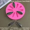 Detailed view of pink silicone mold with 10 sunflower seed cavities and product dimensions - 10-Cavity Sunflower Seeds Mold