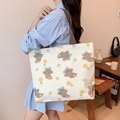 Beige canvas tote bag with brown bear and sunflower print worn by a female model - Sunflower Bear