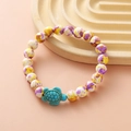 Beaded bracelet with turtle charm featuring yellow and purple spotted round beads - Yellow Purple White Spotted Turtle Bracelet