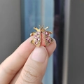 Golden ladybug brooch with pink rhinestones and orange enamel detailing on metal wings - Pink