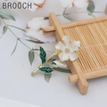 Elegant white camellia flower brooch with green leaves and golden branch in enamel finish - Gardenia Style (X0184)