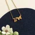 Golden stainless steel necklace featuring a butterfly and initial B pendant with hearts - Gold B