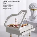 Macro view of white grand piano music box with rotating ballerina and gold trim details - Large Piano with Dancing Girl Music Box