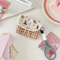 Detailed view of quilted CCD camera bag with bear print and gingham pattern details - Skating Dog