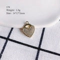 Macro shot of gold heart pendant with inlaid crystals and precise size dimensions - 17# (Heart)