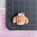 Detailed view of resin teddy dog accessory with pink bow showing size on a cm ruler - Brown Puppy with Bow