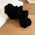 Close-up of black velvet hair claw clip with silver glitter on wooden surface background - Black Glitter Velvet Twist Clip