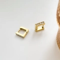 Rectangular gold hoop earrings with channel-set baguette cubic zirconia stones on white base - Square Zirconia