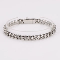 Detailed close-up of polished silver Cuban chain bracelet on clear display stand - 10mm / Silver
