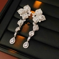 Detail of silver flower and teardrop tassel earrings with zircons in a jewelry box - Silver Petal Leaf Drop Tassel Studs